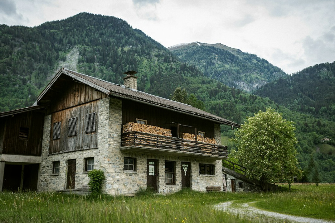 Swiss alpine chalet interior with stone fireplace and wooden beams